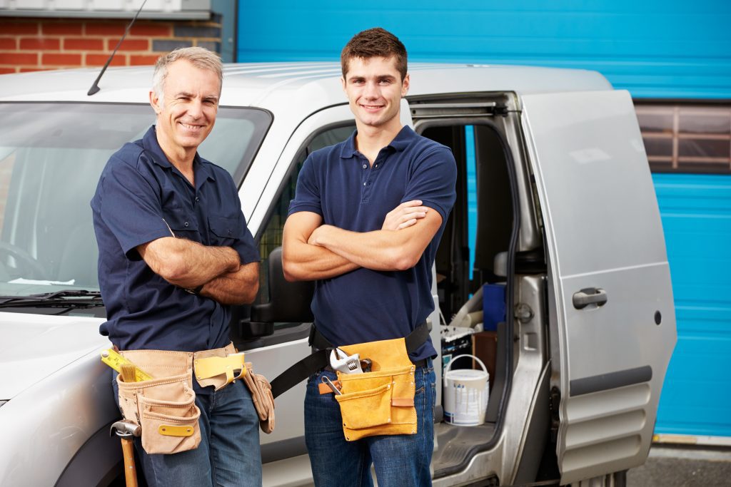 Builders standing by van
