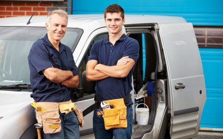 Builders standing by van